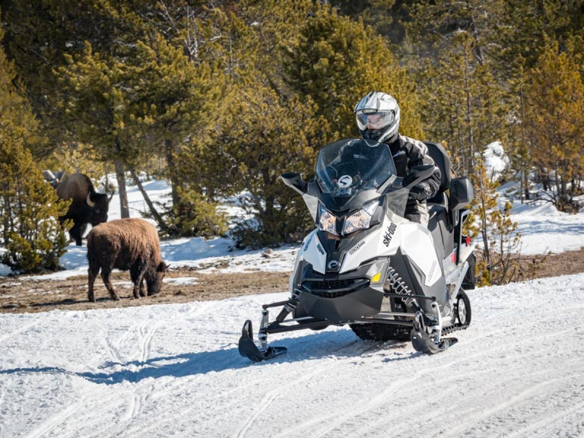 a man riding a motorcycle in the snow