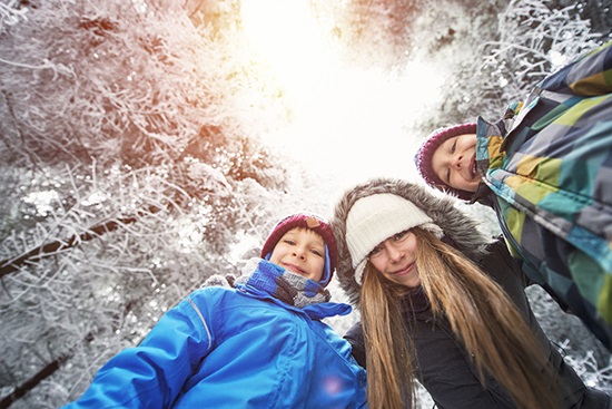 Happy winter kids in frozen forest a person wearing a hat