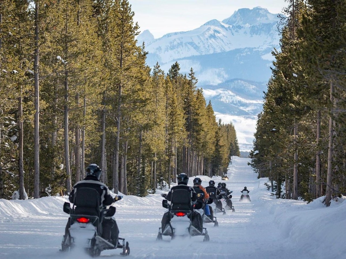 a group of people cross country skiing in the snow