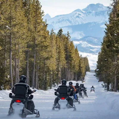 a group of people cross country skiing in the snow