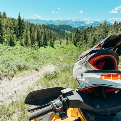 a motorcycle parked on the side of a dirt field