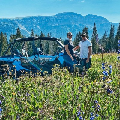 a group of people standing in front of a mountain