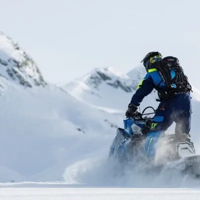 a man riding on top of a snow covered mountain