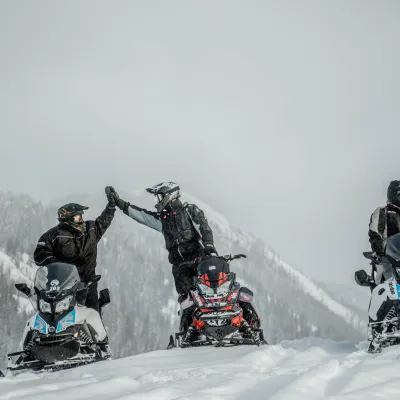 a group of people riding skis on a snowy hill