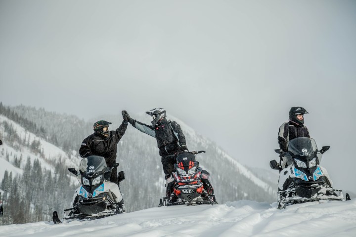 a group of people riding skis on a snowy hill