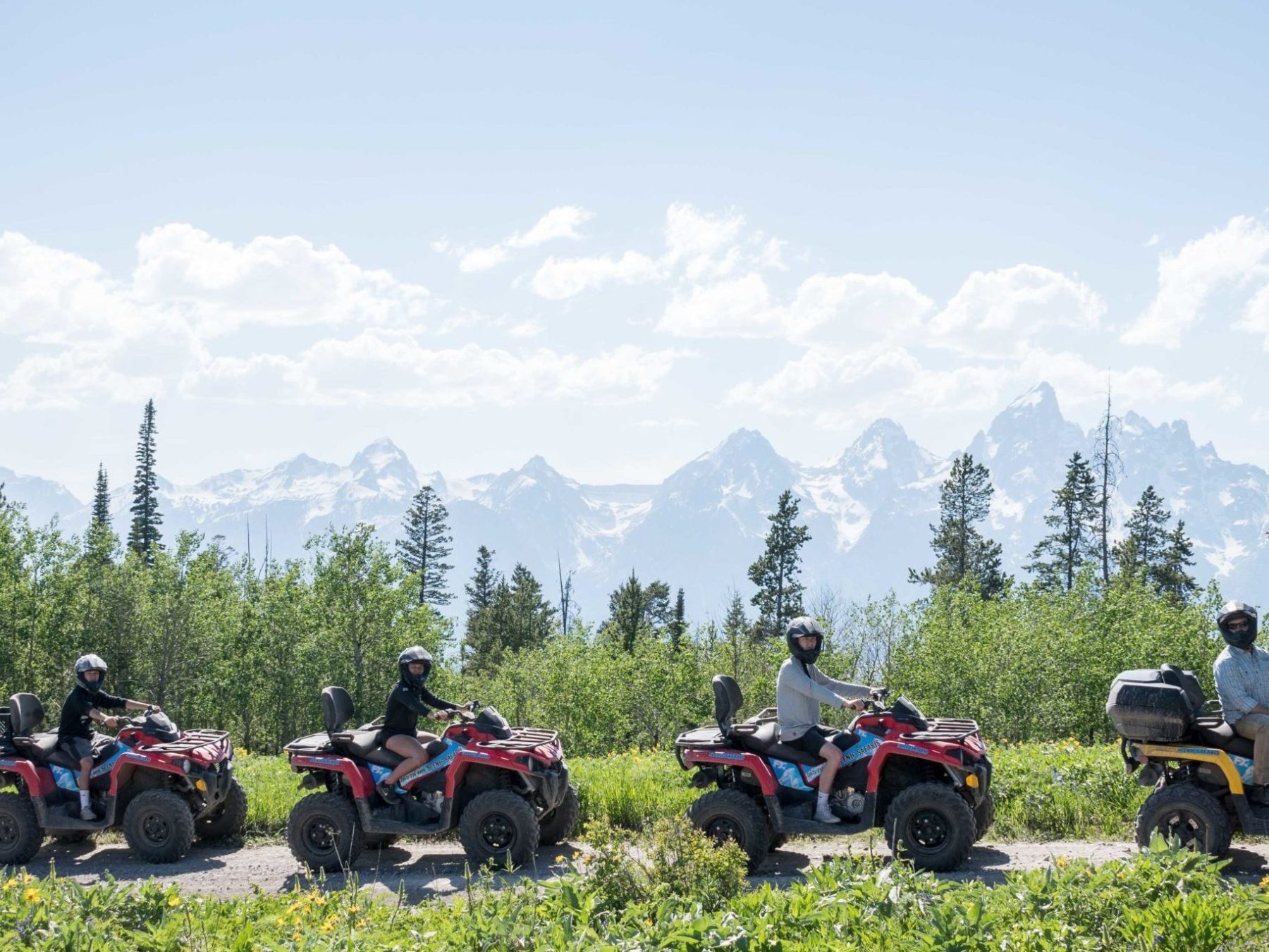a row of parked motorcycles sitting on top of a grass covered field