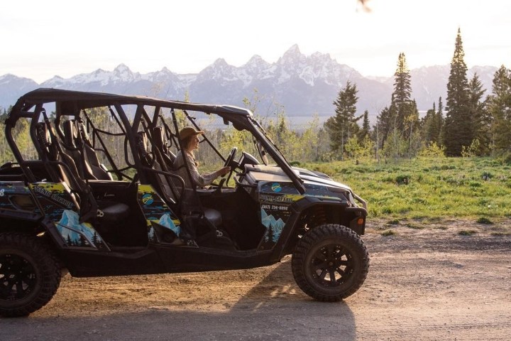 a truck driving down a dirt road
