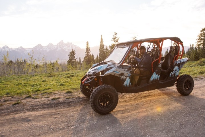 a truck driving down a dirt road