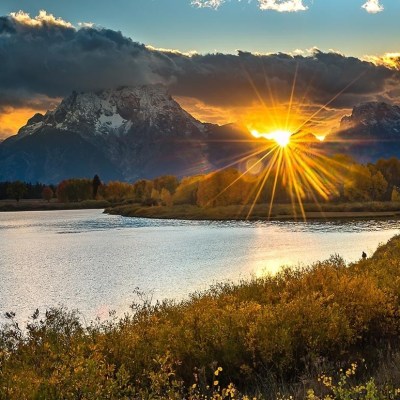a body of water with a mountain in the background