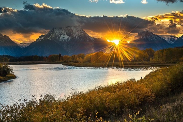 a body of water with a mountain in the background