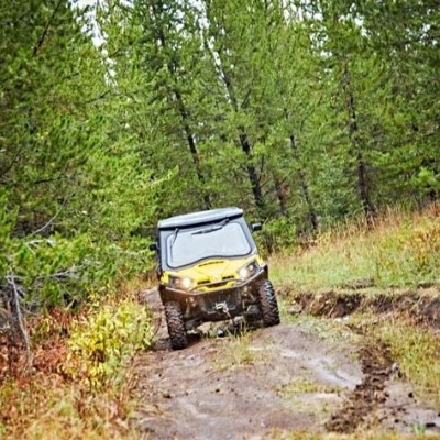 a truck driving down a dirt road