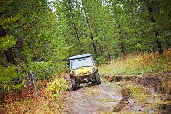 a truck driving down a dirt road