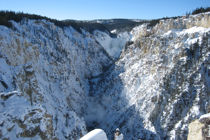 a man riding on top of a snow covered mountain