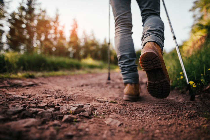 a person walking down a dirt road