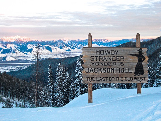 a sign on the side of a snow covered slope