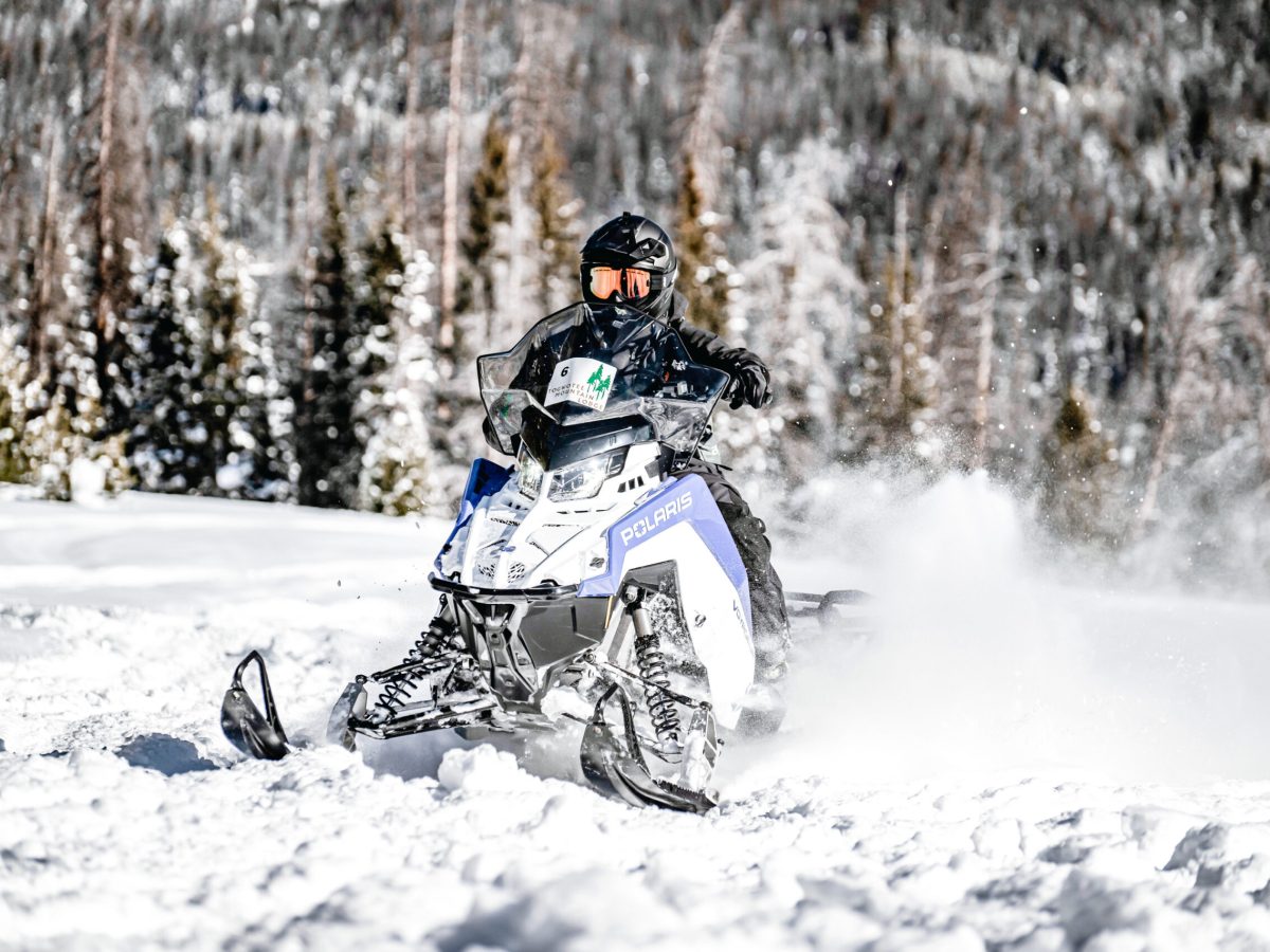 a man riding skis down a snow covered slope