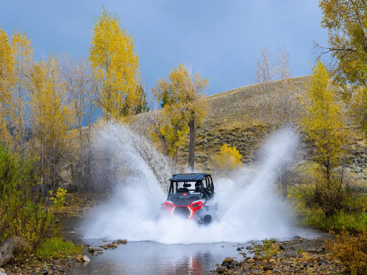 UTV blasting through water in bridger teton national forest