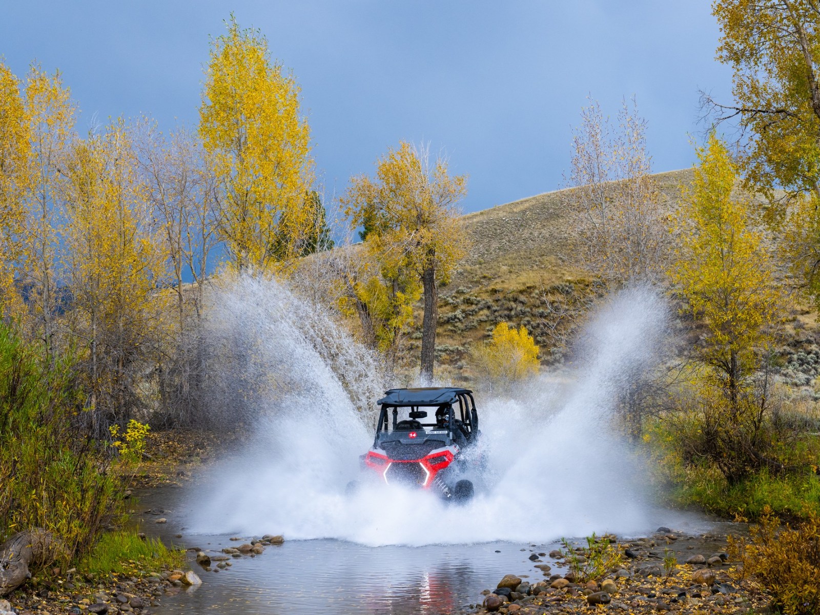 UTV blasting through water in bridger teton national forest