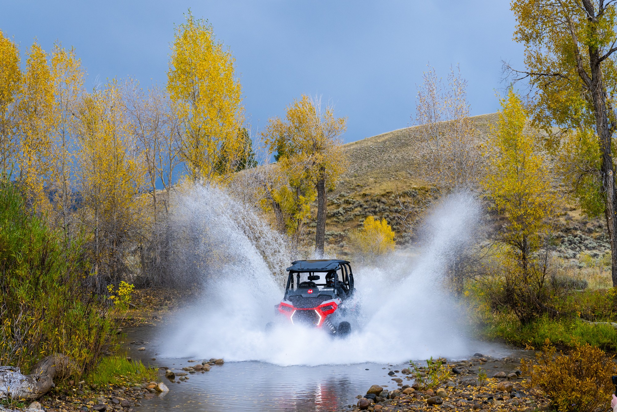 UTV blasting through water in bridger teton national forest